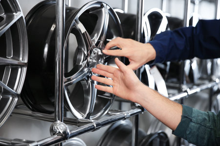 Service center consultant and customer near alloy wheels in store, closeupの写真素材
