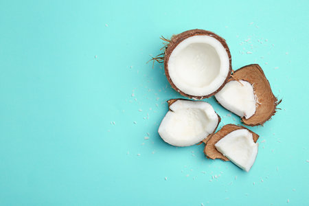Composition with fresh coconut on color background, top view