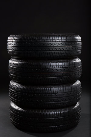 Stack of car tires on black backgroundの写真素材