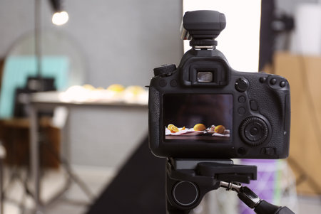 Professional camera on tripod in studio, closeup. food photography