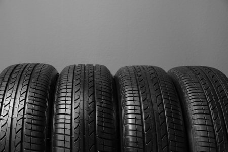 Car tires on gray background, closeupの写真素材