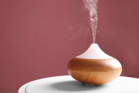 Aroma oil diffuser on table against color backgroundの写真素材