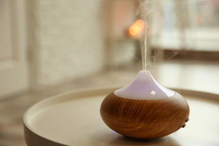 Aroma oil diffuser on table indoorsの写真素材