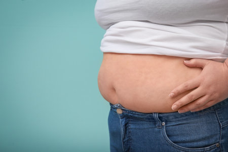 Overweight woman on color background