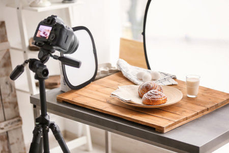 Professional camera on tripod and food composition in photo studioの写真素材