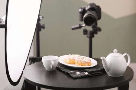 Professional camera on tripod and food composition in photo studioの写真素材