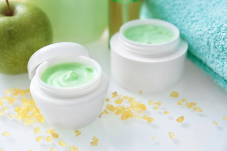 Jars with body care cream on tableの写真素材