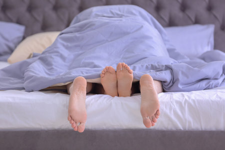 Young couple in bed at home, closeup