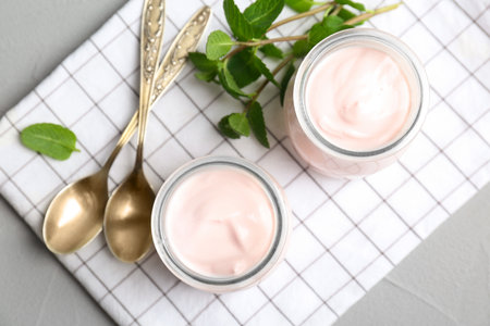 Jars with yummy yogurt on tableの写真素材