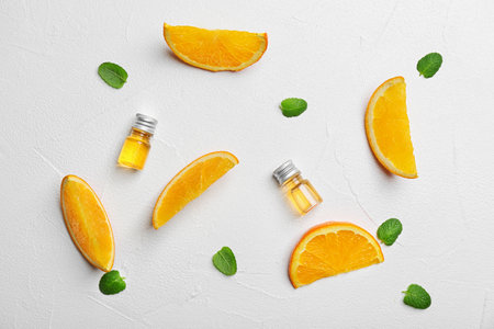 Flat lay composition with orange essential oil on light backgroundの写真素材