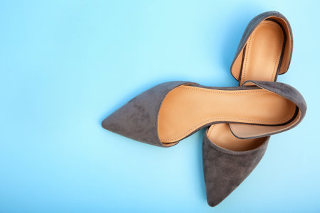 Pair of female shoes on color backgroundの写真素材