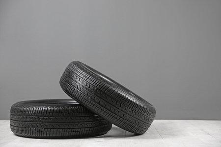 Car tires near gray wall