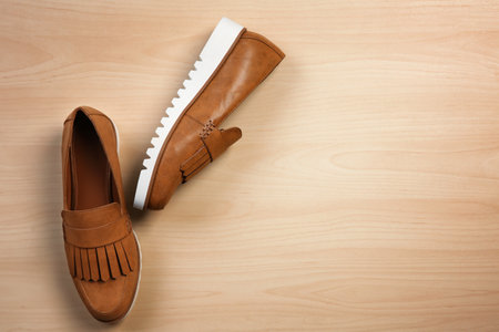 Pair of female shoes on wooden backgroundの写真素材