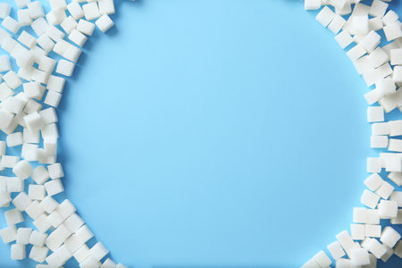 Frame of refined sugar cubes on color background, top viewの写真素材