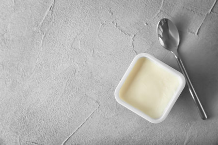 Plastic cup with tasty yogurt on gray background, top viewの写真素材