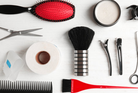 Flat lay composition with professional hairdresser tools on wooden backgroundの写真素材