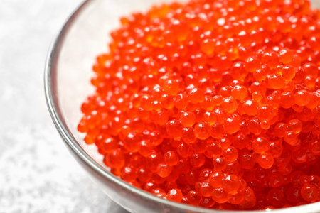 Bowl with delicious red caviar on table, closeupの写真素材