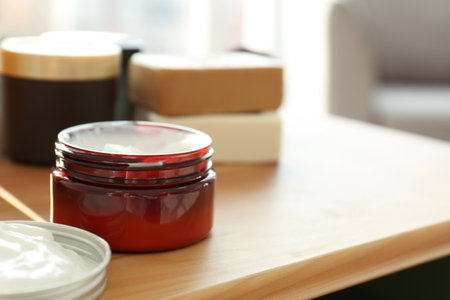 Jar with body care cream on tableの写真素材