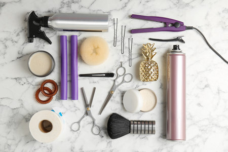 Flat lay composition with professional hairdresser tools on marble backgroundの写真素材