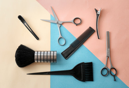 Flat lay composition with professional hairdresser tools on color backgroundの写真素材