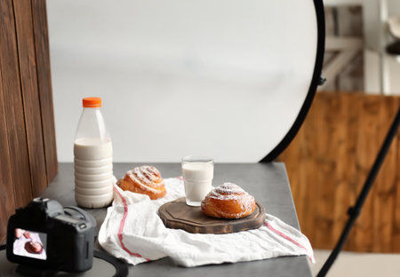 Professional camera and food composition on table in photo studioの写真素材