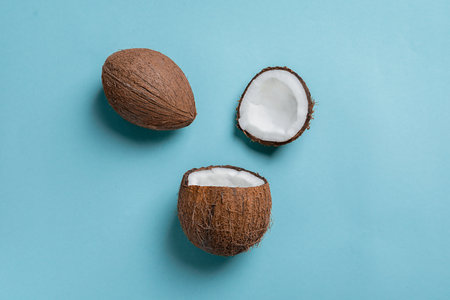 Ripe coconuts on color backgroundの写真素材