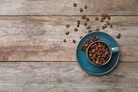 Flat lay composition with cup and coffee beans on wooden backgroundの写真素材