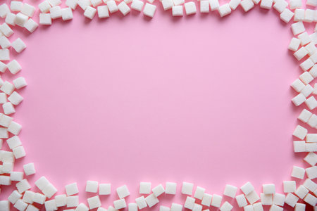 Frame of refined sugar cubes on color background, top viewの写真素材