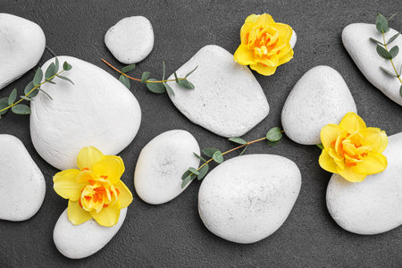 Spa stones and beautiful flowers on gray backgroundの写真素材