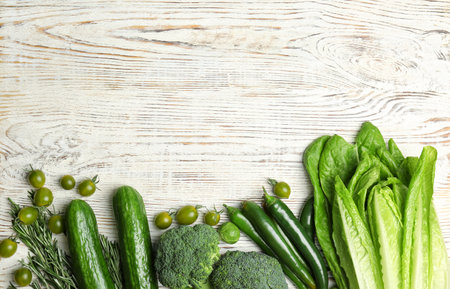 Different green vegetables on wooden background, top viewの写真素材