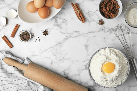 Flat lay composition with flour, eggs and spices on light gray backgroundの写真素材