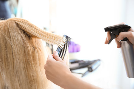 Professional hairdresser working with client in salonの写真素材