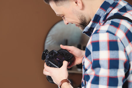 Professional photographer with camera in studio