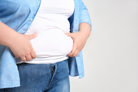 overweight woman on light background