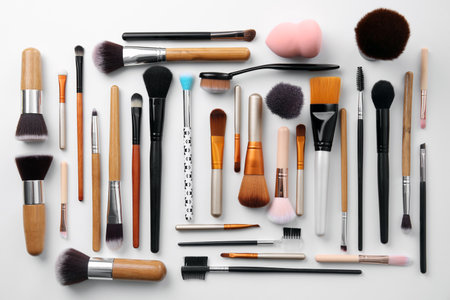 Flat lay composition with makeup brushes of professional artist on white backgroundの写真素材
