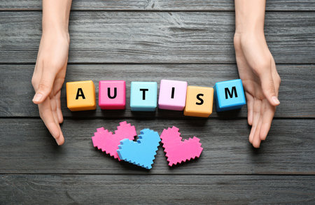 Woman with color cubes on wooden background. autism conceptの写真素材