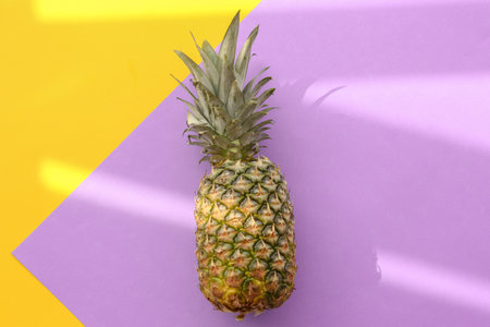 Fresh ripe pineapple on color background, top viewの写真素材