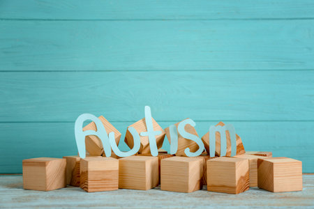 Word "Autism" and wooden cubes on tableの写真素材