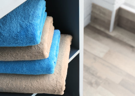 Stack of clean towels on shelfの写真素材