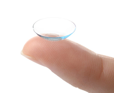 woman holding contact lens on light background, closeupの写真素材