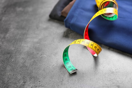 Fabrics and measuring tape for tailoring on gray backgroundの写真素材