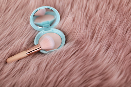 Makeup brush and powder on faux furの写真素材