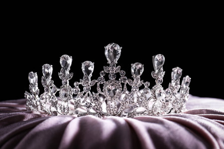 Beautiful silver tiara with diamonds on light clothの写真素材