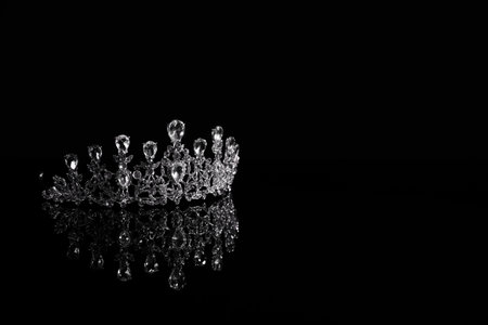 Beautiful silver tiara with diamonds on dark mirror surface. Space for textの写真素材
