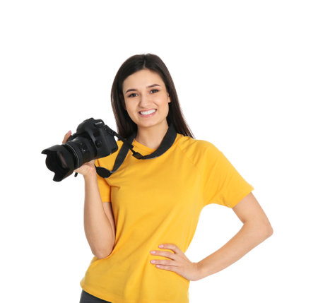 Young female photographer with camera on white background
