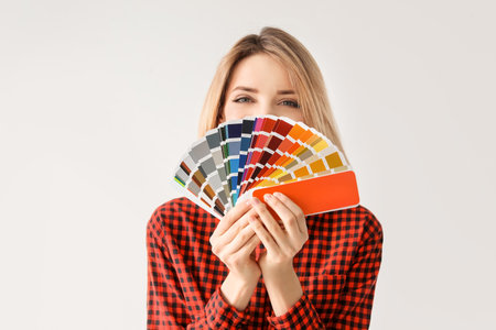 Young woman with color palette on white backgroundの写真素材