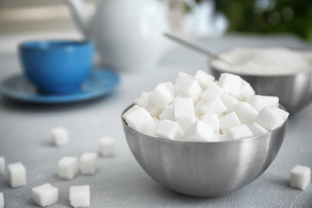 Bowl with refined sugar on tableの写真素材