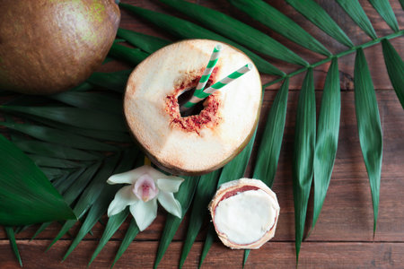 Beautiful composition with fresh green coconut on table, top viewの写真素材