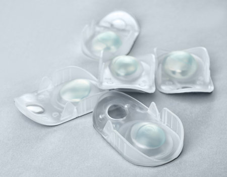 Packages with contact lenses on light background