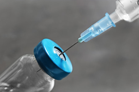 Vial with vaccine and syringe on gray background, closeupの写真素材